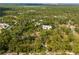 Expansive aerial view showcases the property nestled amidst lush greenery at 202 Laurel Oaks Rd, Nokomis, FL 34275