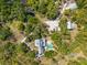 Expansive aerial view of an estate home with a resort-style pool, lush landscaping, and multiple outbuildings at 202 Laurel Oaks Rd, Nokomis, FL 34275