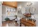 Bright bathroom with a clawfoot tub beneath a window and a wooden ceiling at 202 Laurel Oaks Rd, Nokomis, FL 34275