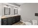 Contemporary bathroom featuring double sinks, dark wood cabinets, modern fixtures, and ample counter space at 202 Laurel Oaks Rd, Nokomis, FL 34275