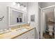 Bathroom with a decorative mirror, modern sink fixtures, and an adjoining shower and toilet at 202 Laurel Oaks Rd, Nokomis, FL 34275