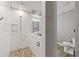 Modern bathroom features a subway-tiled walk-in shower with pebble floor at 202 Laurel Oaks Rd, Nokomis, FL 34275