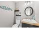 Stylish powder room with wood countertop vanity, modern fixtures, and coastal-themed decor at 202 Laurel Oaks Rd, Nokomis, FL 34275