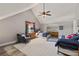 Comfortable bedroom with vaulted ceilings, ceiling fan, plush carpeting and a sitting area at 202 Laurel Oaks Rd, Nokomis, FL 34275