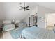 Bright bedroom with three beds, vaulted ceilings, and an open closet for clothing storage at 202 Laurel Oaks Rd, Nokomis, FL 34275
