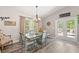 Charming dining area with stylish table, chair set, chandelier, and access to the outdoor patio at 202 Laurel Oaks Rd, Nokomis, FL 34275