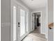 Bright entryway with gray walls, wood-look flooring, and a modern front door at 202 Laurel Oaks Rd, Nokomis, FL 34275