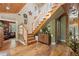 Grand foyer with wooden staircase, hardwood floors, and decorative accents creating an inviting entrance at 202 Laurel Oaks Rd, Nokomis, FL 34275