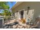 Comfortable front porch with brick pavers, seating, and a vibrant flower arrangement near the front door at 202 Laurel Oaks Rd, Nokomis, FL 34275
