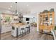 Open concept kitchen boasting a central island and seamlessly flowing into the cozy living area at 202 Laurel Oaks Rd, Nokomis, FL 34275