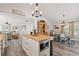 Open kitchen with an island seamlessly flows into a dining area and additional living spaces at 202 Laurel Oaks Rd, Nokomis, FL 34275