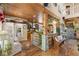 Spacious kitchen with decorative wood beam and stone accents, seating area, and hardwood flooring at 202 Laurel Oaks Rd, Nokomis, FL 34275