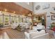 Bright living room featuring hardwood floors, vaulted wood ceilings, and numerous windows at 202 Laurel Oaks Rd, Nokomis, FL 34275