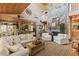 Spacious living area with a stone fireplace, vaulted ceilings and hardwood flooring at 202 Laurel Oaks Rd, Nokomis, FL 34275