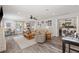 Cozy living room boasting wood-look floors, ceiling fan, neutral walls, and convenient laundry access at 202 Laurel Oaks Rd, Nokomis, FL 34275