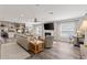 Open concept living room flows to the kitchen, complete with wood-look floors and neutral color palette at 202 Laurel Oaks Rd, Nokomis, FL 34275