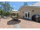 Outdoor patio features brick pavers, dining table, grill, and lounge chair at 202 Laurel Oaks Rd, Nokomis, FL 34275