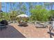 Brick patio offers an umbrella dining table, a grill, and a seating area at 202 Laurel Oaks Rd, Nokomis, FL 34275