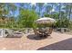 Brick patio features a dining table and chairs plus lounge chairs in fenced yard at 202 Laurel Oaks Rd, Nokomis, FL 34275