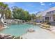 Backyard oasis featuring a large pool with waterfall, slide, and rock features at 202 Laurel Oaks Rd, Nokomis, FL 34275