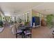 Large covered porch with seating and dining areas, perfect for outdoor entertaining and relaxation at 202 Laurel Oaks Rd, Nokomis, FL 34275