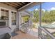 Covered porch offering a view of the pool, waterfalls, and natural rock features at 202 Laurel Oaks Rd, Nokomis, FL 34275