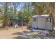 Outdoor shed with a concrete base, along with a chicken coop in the backyard at 202 Laurel Oaks Rd, Nokomis, FL 34275