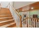 Elegant staircase with wood steps and white railings and hardwood ceiling at 202 Laurel Oaks Rd, Nokomis, FL 34275