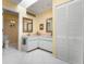 Bright bathroom features a double vanity, skylight, and a separate toilet area for added convenience at 226 Southampton Ln # 257, Venice, FL 34293