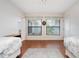 Sunlit bedroom has hard wood floors, two windows, two beds, and neutral decor at 226 Southampton Ln # 257, Venice, FL 34293