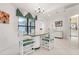 Dining room featuring a glass table with white chairs and bright natural light at 226 Southampton Ln # 257, Venice, FL 34293