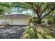 Charming single-story home featuring a lush yard, mature trees, and a two-car garage at 226 Southampton Ln # 257, Venice, FL 34293