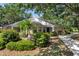 Well-maintained single-Gathering home with lush landscaping, mature trees, and a paved walkway at 226 Southampton Ln # 257, Venice, FL 34293