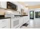 Kitchen with white appliances and cabinets, plus a view of the backyard at 226 Southampton Ln # 257, Venice, FL 34293