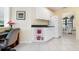 Kitchen featuring white cabinets, dark countertops, and a refrigerator at 226 Southampton Ln # 257, Venice, FL 34293