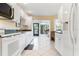 Bright, traditional kitchen with white cabinets and views to the backyard at 226 Southampton Ln # 257, Venice, FL 34293