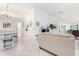 Bright living room with high ceilings, tile flooring, and access to kitchen and dining areas at 226 Southampton Ln # 257, Venice, FL 34293