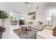 Bright living room with neutral furniture, tile flooring, and views to the outdoors at 226 Southampton Ln # 257, Venice, FL 34293