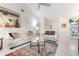 Bright living room featuring white sofas, a glass-top table, and neutral decor at 226 Southampton Ln # 257, Venice, FL 34293