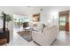 Bright living room with neutral furniture, tile flooring, and views to the outdoors at 226 Southampton Ln # 257, Venice, FL 34293