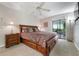 Spacious main bedroom with a large bed, ceiling fan, and access to the outdoor area through sliding doors at 226 Southampton Ln # 257, Venice, FL 34293