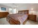 Spacious main bedroom featuring a large bed, dresser, and nightstands at 226 Southampton Ln # 257, Venice, FL 34293