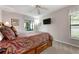 Comfortable main bedroom featuring a ceiling fan, TV, and sliding glass doors to the outside at 226 Southampton Ln # 257, Venice, FL 34293