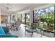 Inviting sunroom with tile floors, a dining set, and large windows offering serene lake views at 226 Southampton Ln # 257, Venice, FL 34293