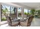 Bright sunroom featuring large windows, water views, and comfortable seating at 226 Southampton Ln # 257, Venice, FL 34293
