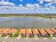 Aerial view of the community highlighting the lake, surrounding landscape, and street layout at 24128 Spartina Dr, Venice, FL 34293