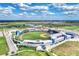 Expansive aerial view of a baseball stadium surrounded by green fields and modern facilities at 24128 Spartina Dr, Venice, FL 34293