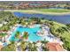 Aerial view of the community pool area featuring lush landscaping, resort-style pool, and comfortable lounge areas at 24128 Spartina Dr, Venice, FL 34293
