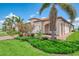 Stunning exterior featuring a red brick walkway, neutral stucco, and manicured landscaping at 24128 Spartina Dr, Venice, FL 34293