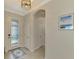 Welcoming foyer with tiled floor, arched doorway and decorative lighting at 24128 Spartina Dr, Venice, FL 34293